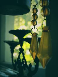 Close-up of illuminated lamp hanging against wall at home