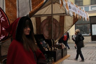 Women standing at store in city