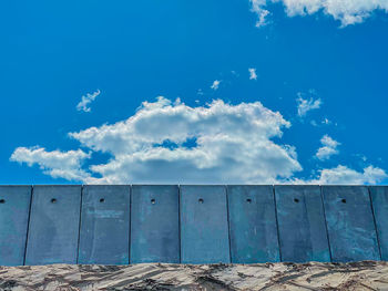Low angle view of metallic structure against blue sky
