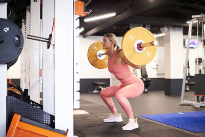 A strong athletic female working out with weights.