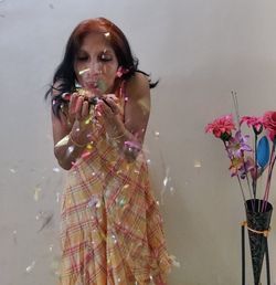 Portrait of young woman holding flower