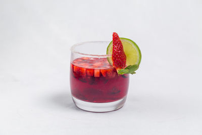 Close-up of fruit and drink against white background