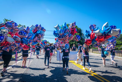 People on street against blue sky