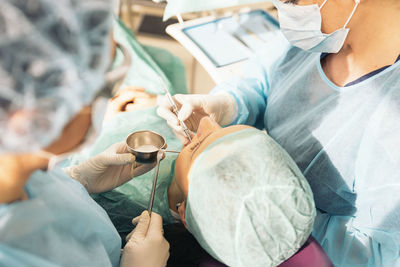 Female dentists examining patient at clinic