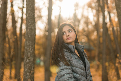 Young woman standing in forest