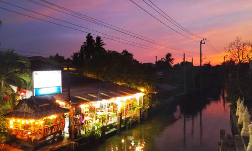 Electricity pylon against cloudy sky