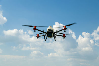 Low angle view of airplane flying against sky