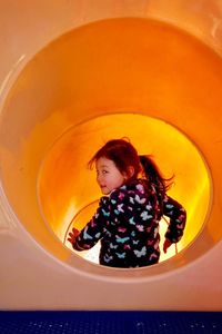 Portrait of girl playing in slide