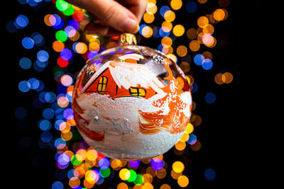 Cropped hand of woman holding christmas decoration