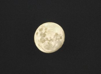 Low angle view of moon against clear sky at night