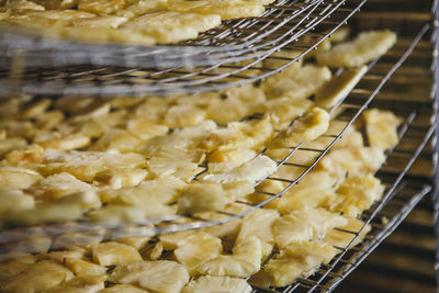 Close-up of pineapple slices on metal grates