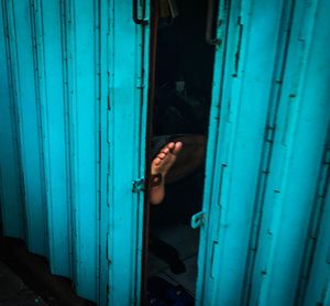 Reflection of man on blue door