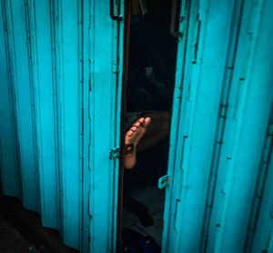 Reflection of man on blue door