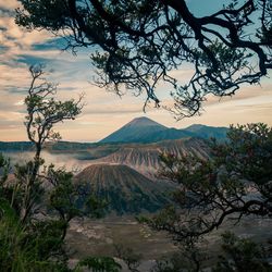 Scenic view of volcanic landscape against cloudy sky