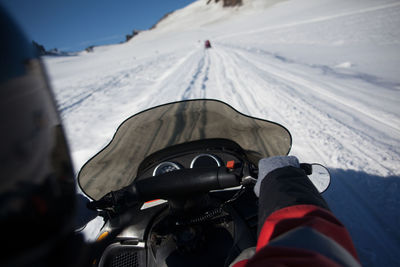 Person riding snowmobile on mountains