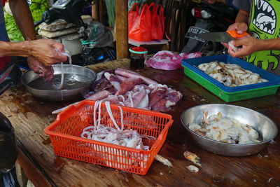 High angle view of man preparing fish in market