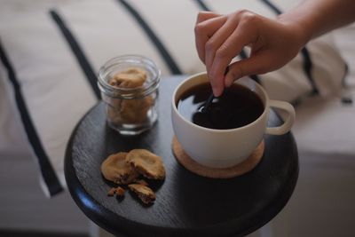 Cropped image of woman having black coffee