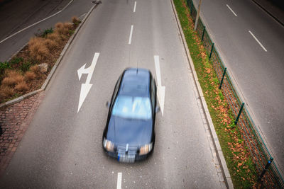 High angle view of arrow symbol on road in city