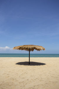 Lifeguard hut on beach against sky