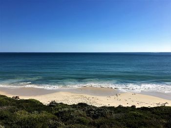 Scenic view of sea against clear blue sky