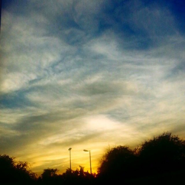 sunset, silhouette, sky, low angle view, cloud - sky, beauty in nature, tree, tranquility, scenics, orange color, tranquil scene, nature, dramatic sky, cloud, street light, cloudy, idyllic, dusk, moody sky, outdoors