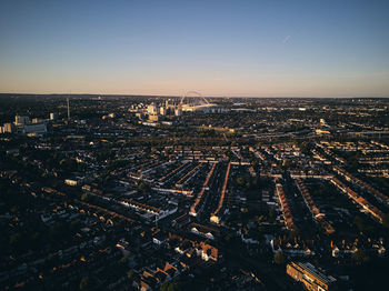 High angle view of illuminated city against sky during sunset