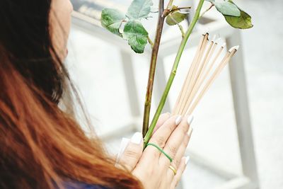 Woman holding incense sticks