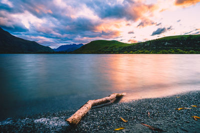 Scenic view of lake against sky during sunset