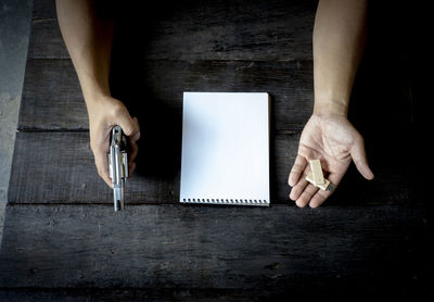 Midsection of man using laptop on table