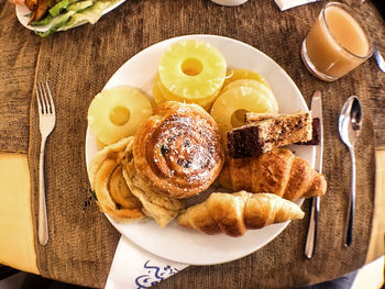 High angle view of cookies and donuts in plate on table at home