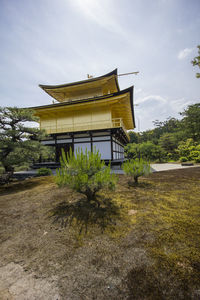 Temple by building against sky