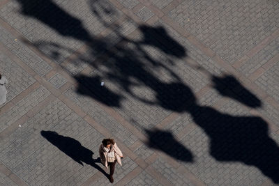 High angle view of woman shadow on floor