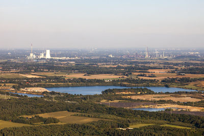 Buildings on landscape against sky