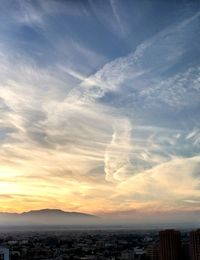 Scenic view of sea and buildings against sky during sunset