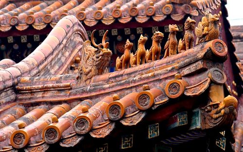 Low angle view of carving on building roof