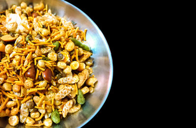 Close-up of pasta in bowl against black background