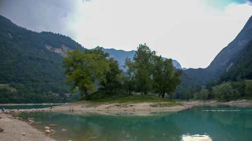 Scenic view of lake by trees against sky