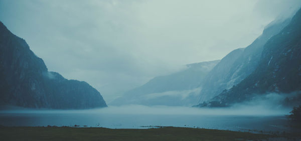 Scenic view of lake and mountains against sky