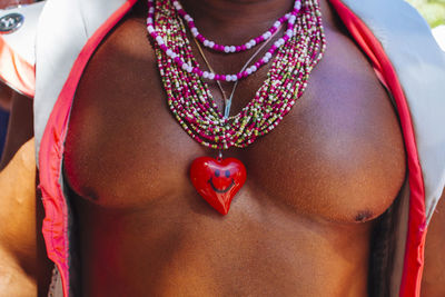 Shirtless of man wearing necklaces