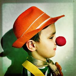 Close-up of boy in clown costume