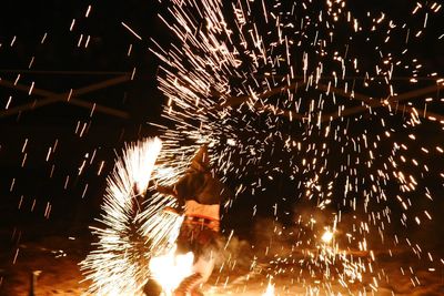 Low angle view of firework display at night