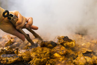 Cropped hand of person preparing food