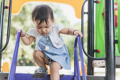 Full length of cute baby girl sitting in bus