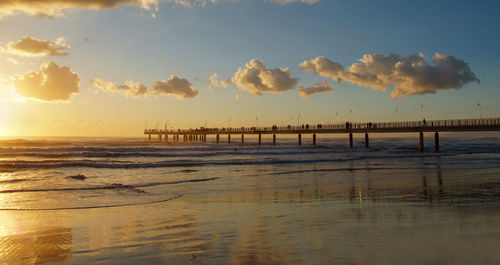 Scenic view of beach against sky during sunset