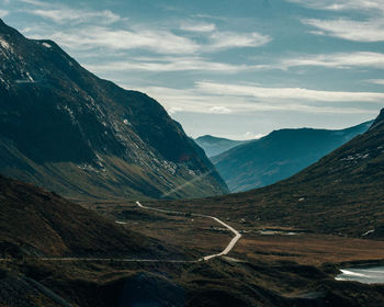 Small road in massive layered mountain range