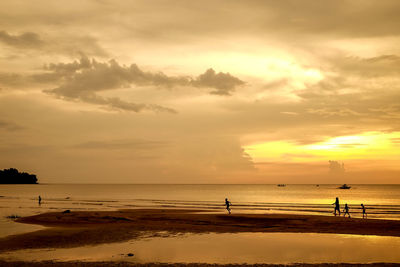 Scenic view of beach against sky during sunset