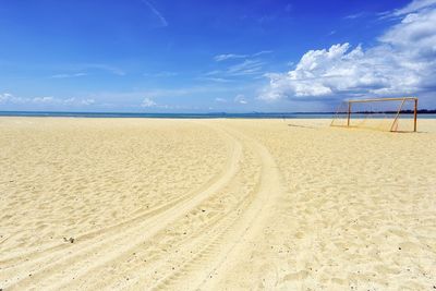 Scenic view of beach against blue sky