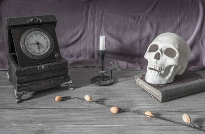Antique clock with candlestick holder and skull