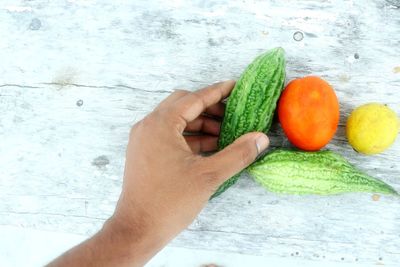 Cropped image of person holding fruits