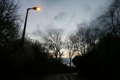 View of illuminated street lights at night